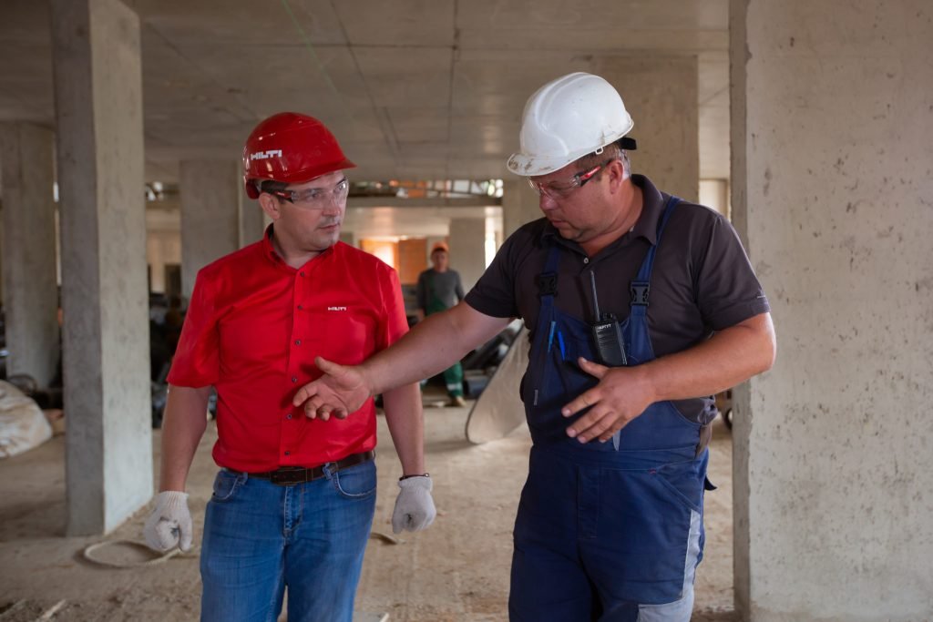 men touring plant with hard hats